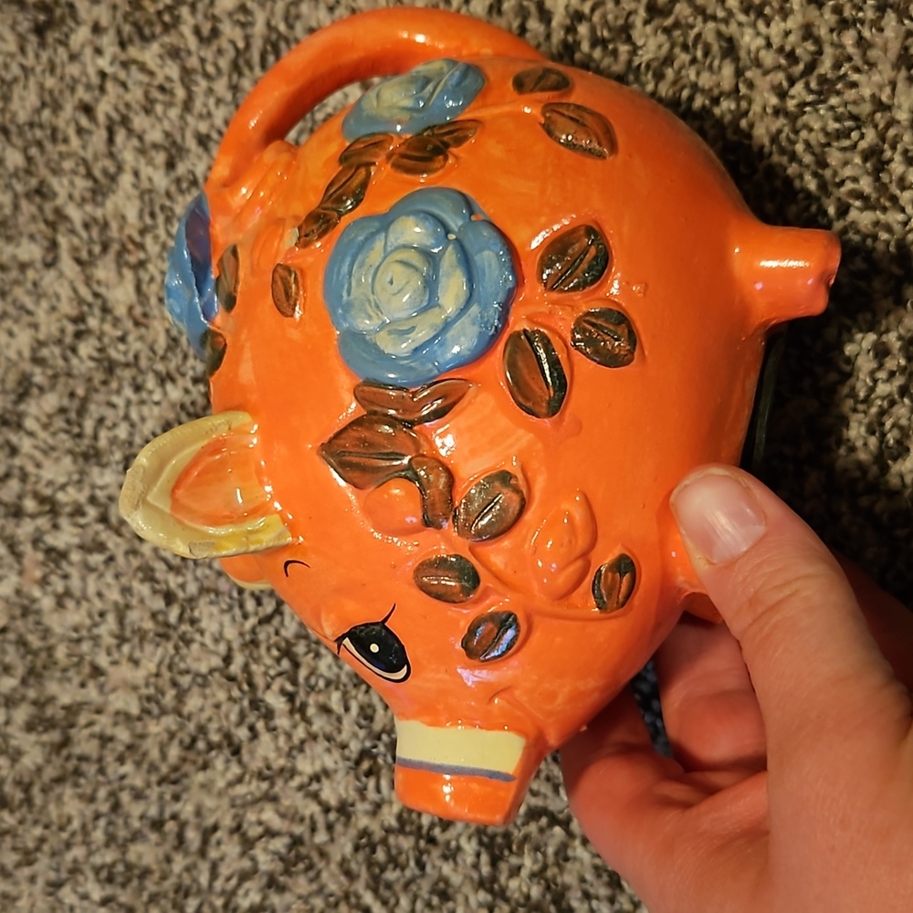 Vintage pink piggy bank. Pink with blue flowers on it